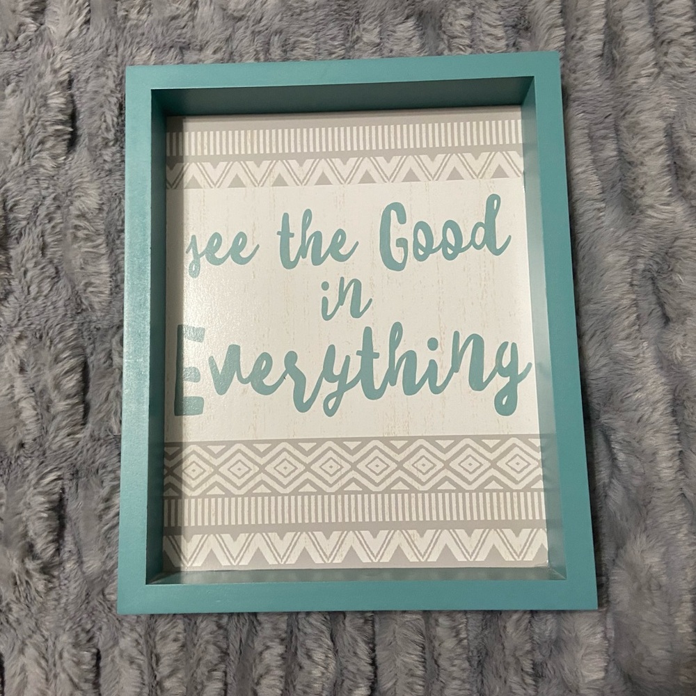 Blue, gray, and white decorative plaque.